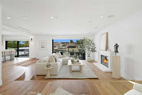 a living room with fireplace furniture and a wooden floor