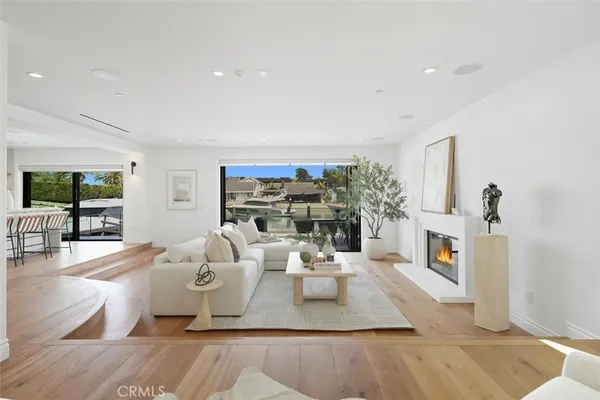 a living room with furniture a chandelier and a large window