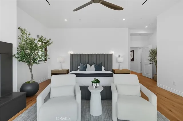 a bedroom with a bed potted plant and a dresser
