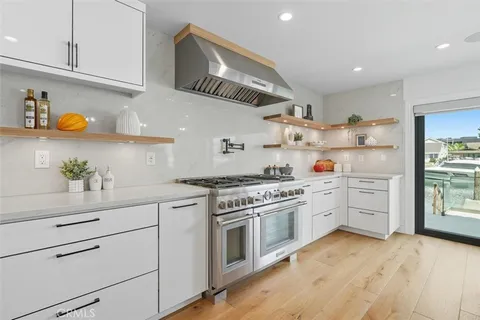 a kitchen with white cabinets and appliances
