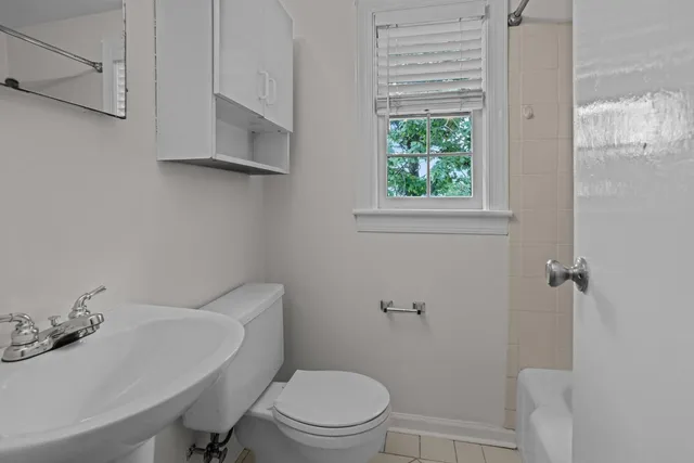 a white toilet sitting next to a bathroom sink