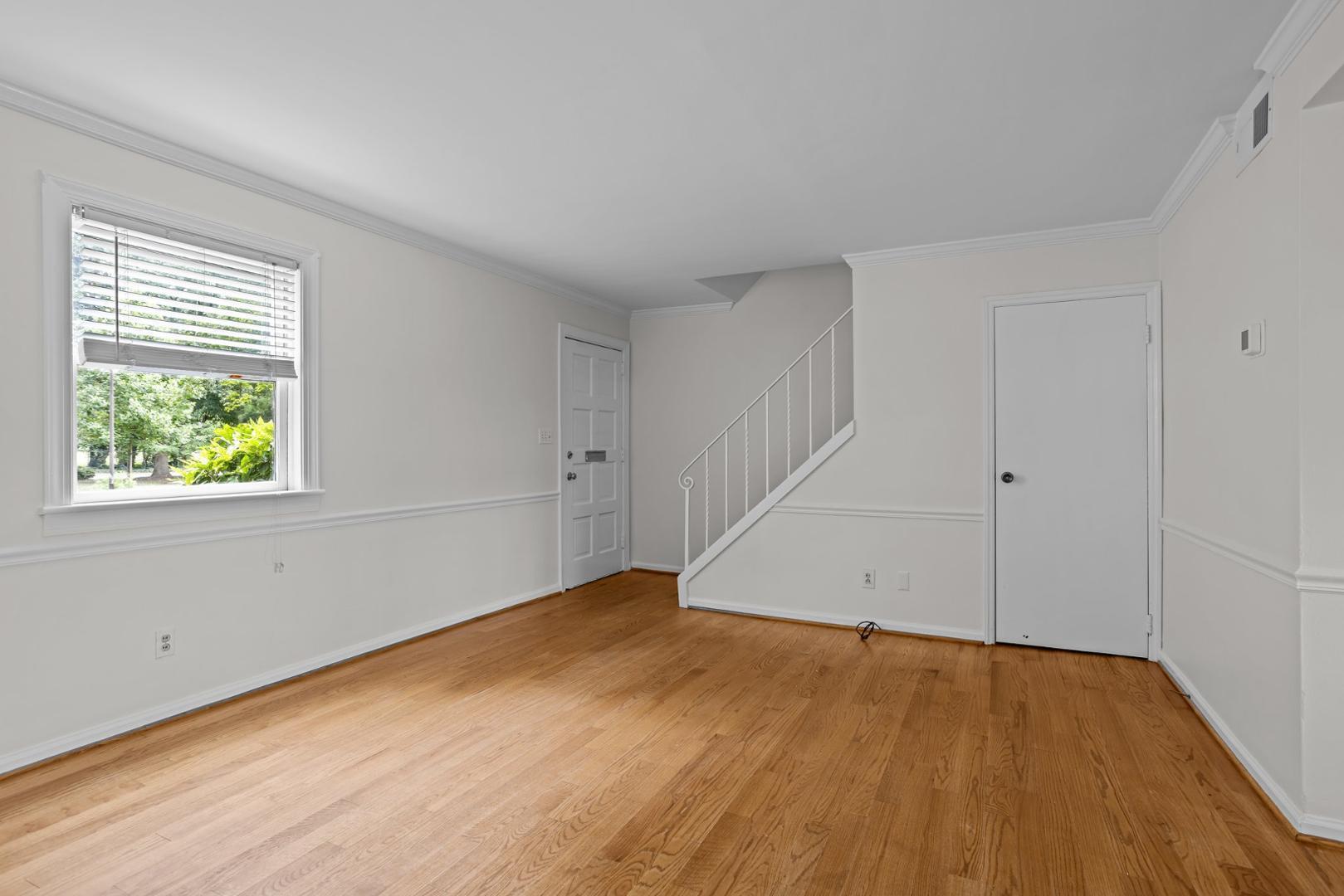 921 St Marys Street Raleigh, NC 27605 - Photo 3 of 42 an empty room with wooden floor and windows