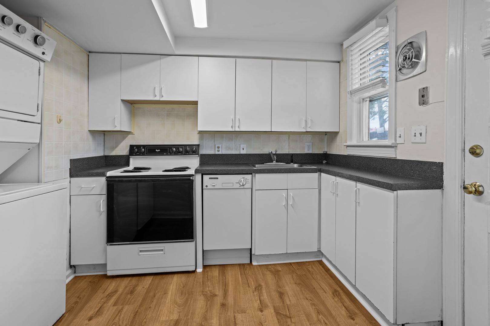 921 St Marys Street Raleigh, NC 27605 - Photo 6 of 42 a kitchen with stainless steel appliances a stove a microwave and a hard wood floors