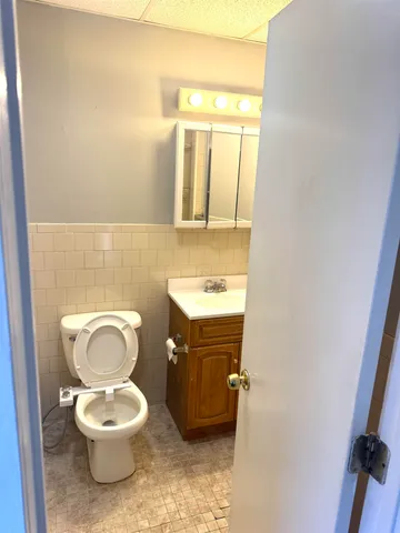 a bathroom with a toilet a sink and a mirror