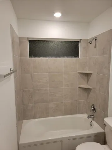 a bathroom with a bathtub and a shower