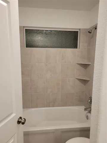 a bathroom with a shower and a bathtub