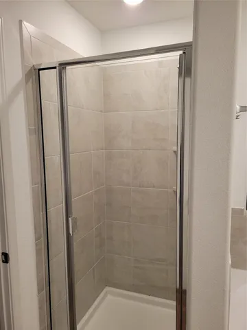 a bathroom with a glass shower door