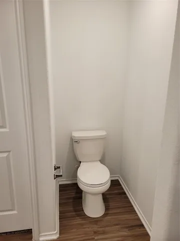 a white toilet sitting in a bathroom
