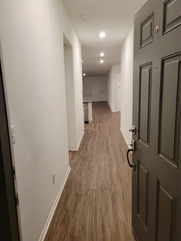 a view of hallway with wooden floor