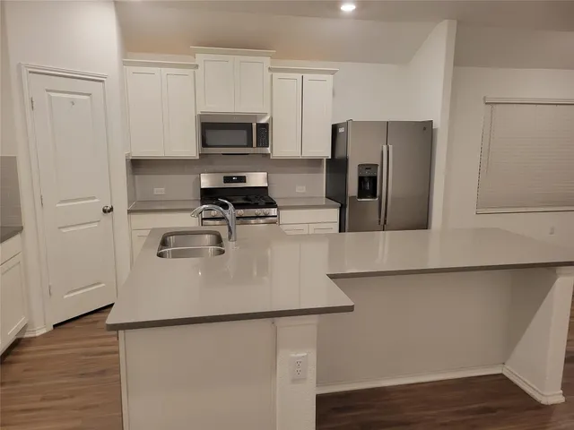 a kitchen with wooden cabinets and stainless steel appliances