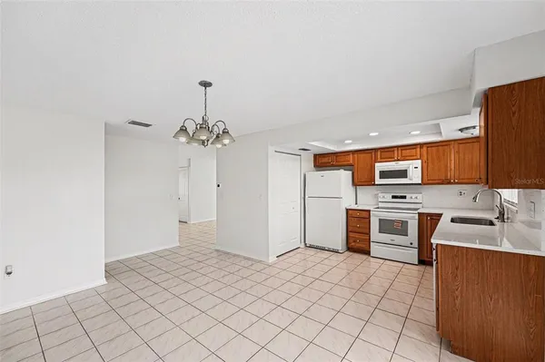 a kitchen with stainless steel appliances a sink stove and cabinets