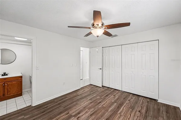 a view of a room with wooden floor and fan