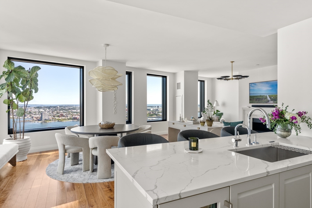 a view of a kitchen with kitchen island granite countertop a sink and a large window