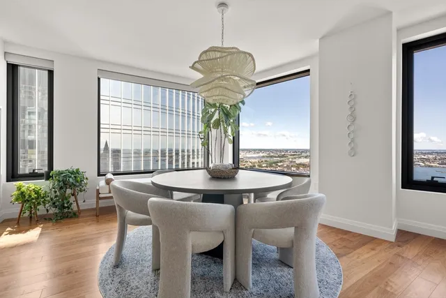 a view of a dining room with furniture window and wooden floor