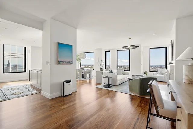 a living room with fireplace furniture and a wooden floor