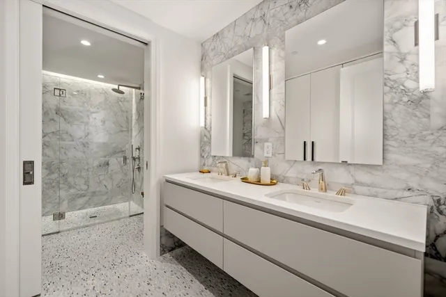 a bathroom with a shower sink and mirror