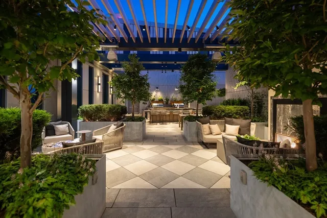 a view of a patio with couches and potted plants