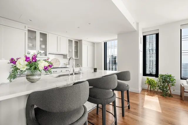 a dining room with furniture and wooden floor