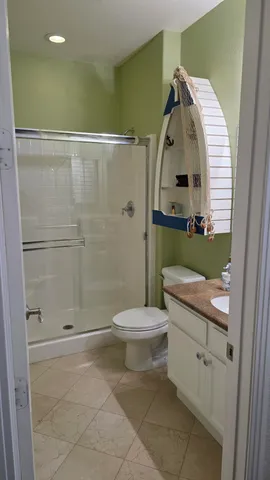 a bathroom with a toilet sink and shower