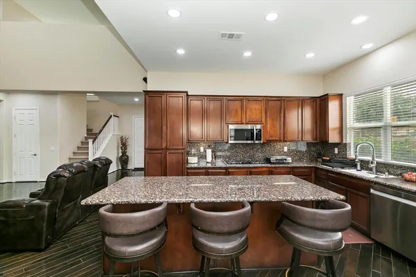 a kitchen with sink a table and chairs