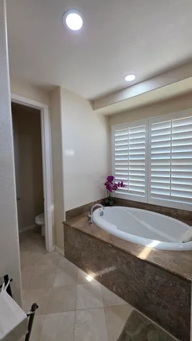 a bathroom with a granite countertop sink a mirror and a shower
