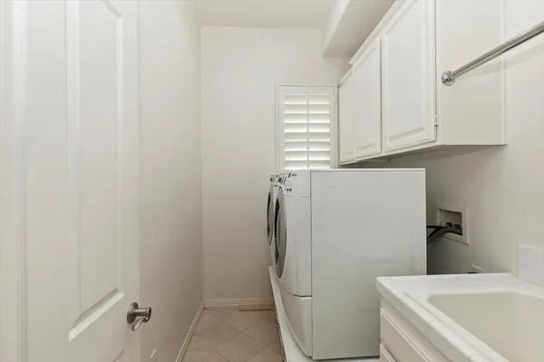 a bathroom with a sink and a washer dryer