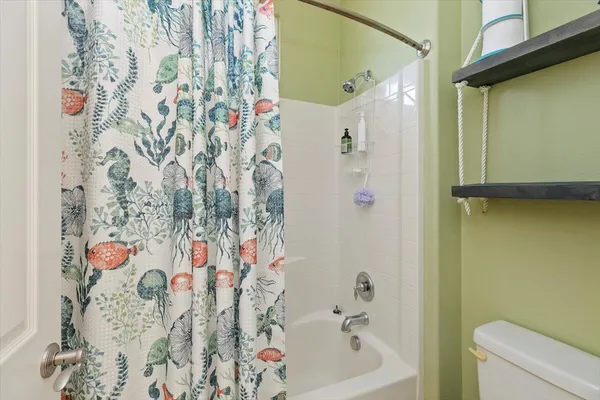 a bathroom with a bathtub and shower curtain
