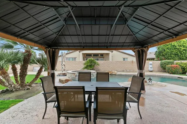 a view of an outdoor space with table and chair under an umbrella