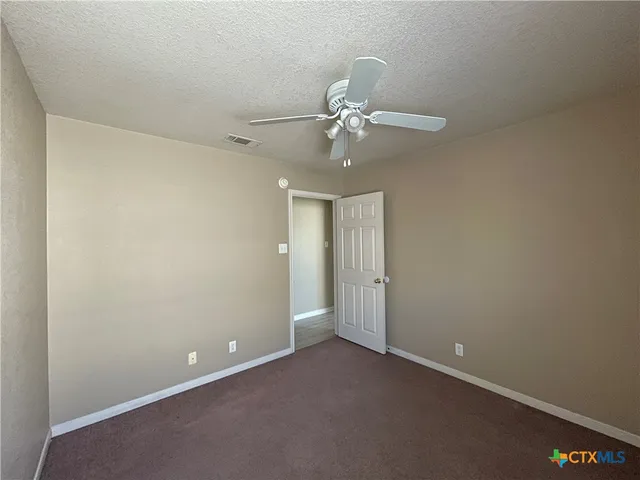 a view of an empty room with a fan