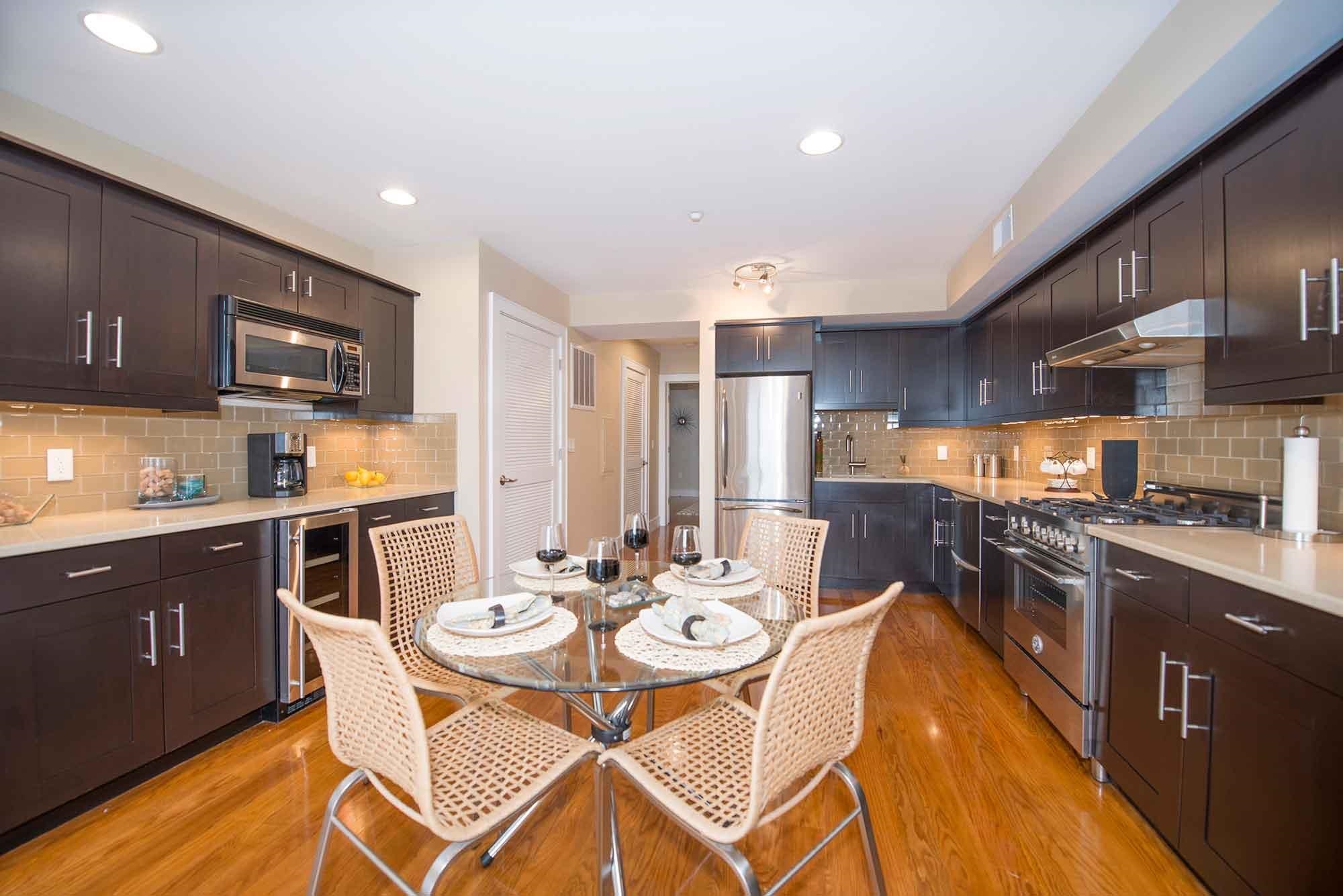 8917 Old River Road, Unit 1 Edgewater, NJ 07047 - Photo 4 of 6 a kitchen with stainless steel appliances kitchen island granite countertop a sink and cabinets