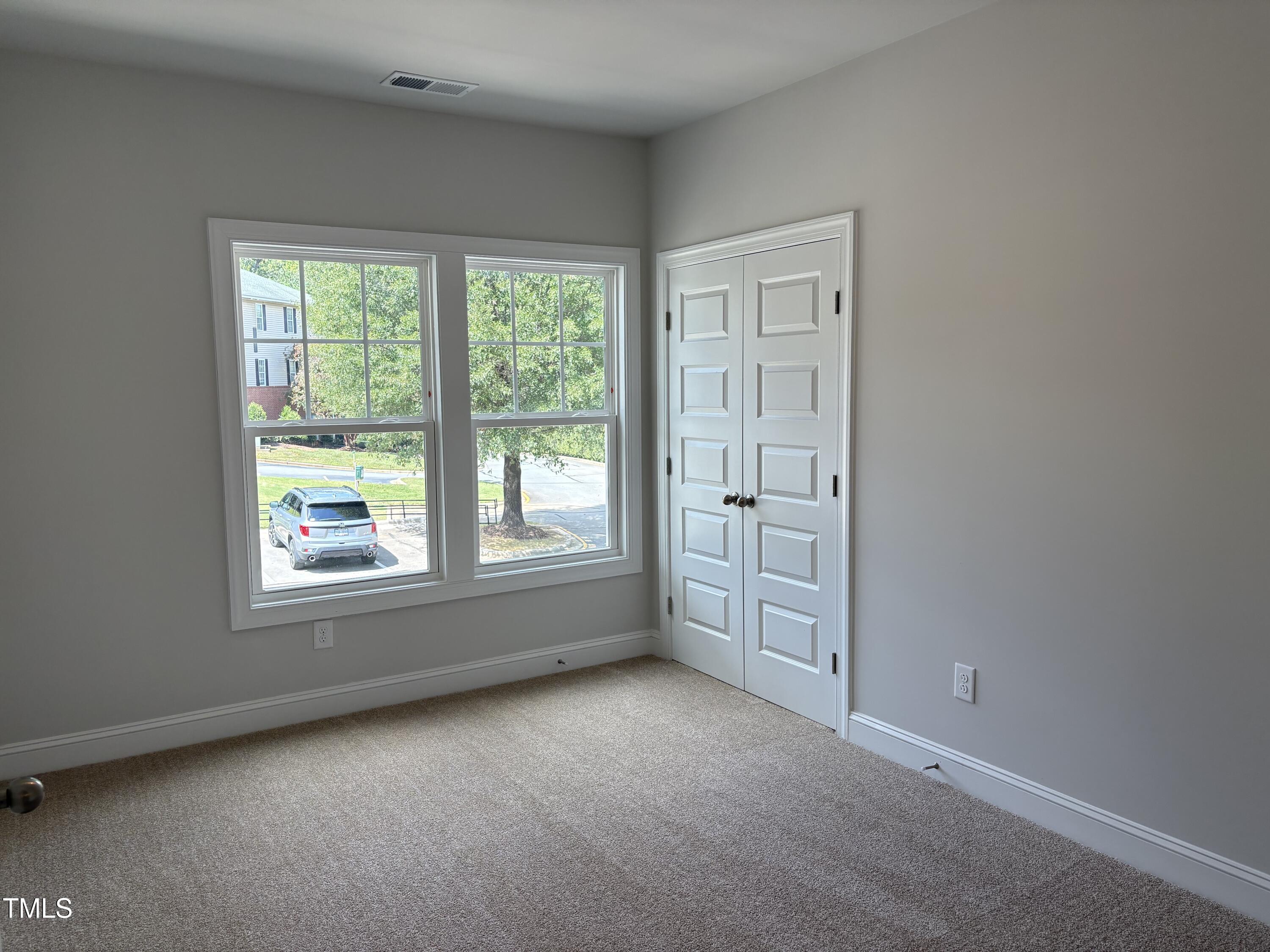 621 Weather Ridge Lane, Unit 33 Cary, NC 27513 - Photo 11 of 20 an empty room with windows and closet