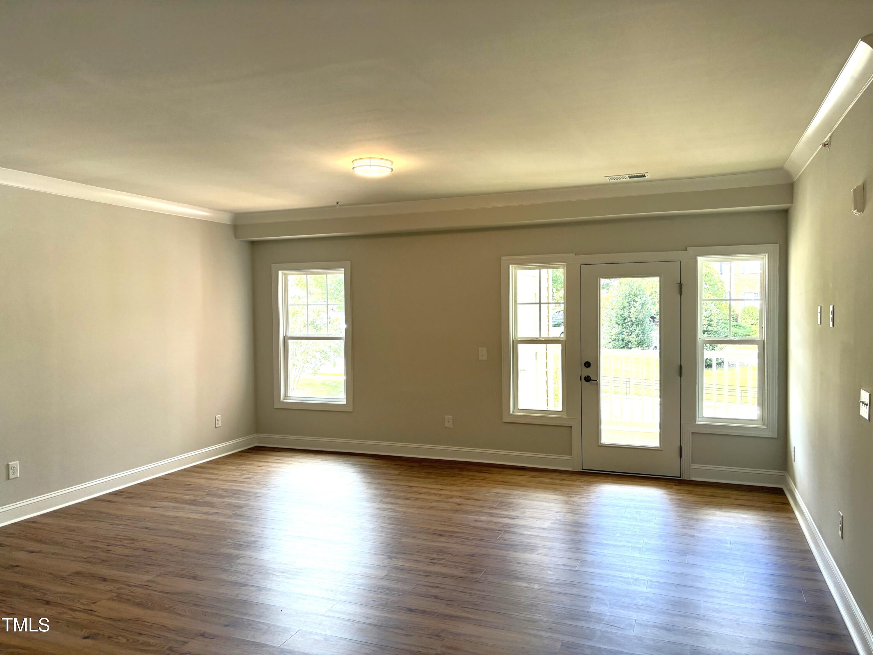 621 Weather Ridge Lane, Unit 33 Cary, NC 27513 - Photo 8 of 20 wooden floor in an empty room with a window