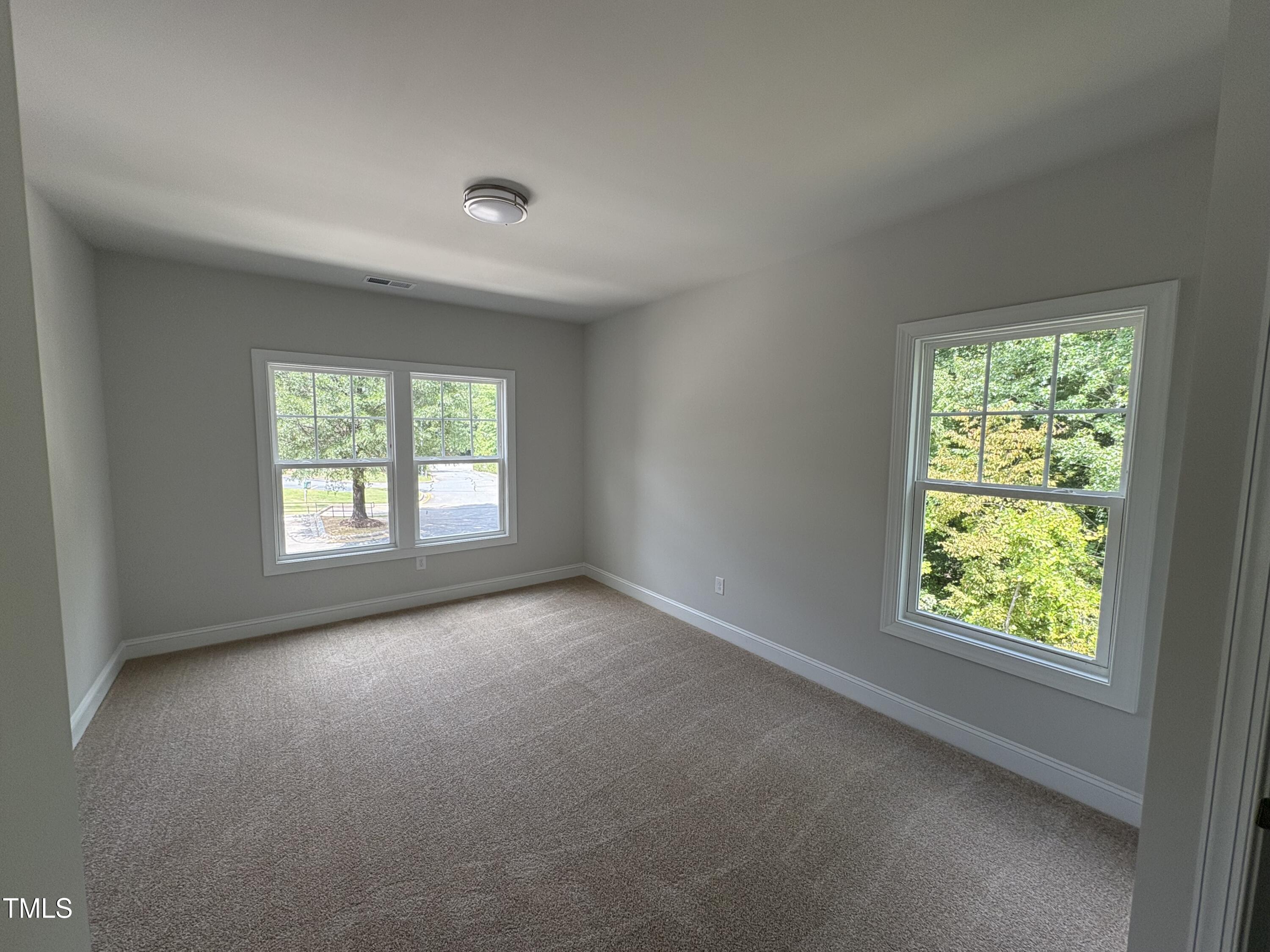621 Weather Ridge Lane, Unit 33 Cary, NC 27513 - Photo 9 of 20 an empty room with windows