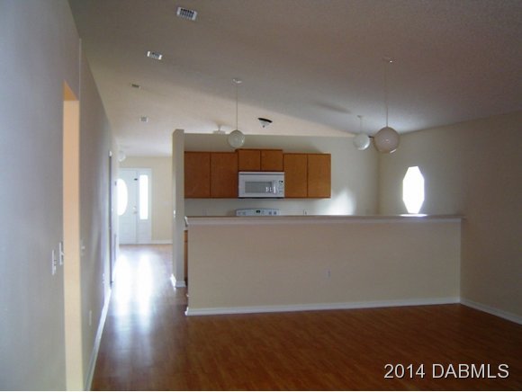 1710 Concert Road Deltona, FL 32738 - Photo 12 of 20 a view of a hallway with wooden floor and front door