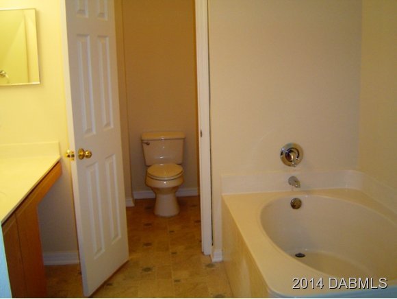 1710 Concert Road Deltona, FL 32738 - Photo 3 of 20 a bathroom with a bathtub and a toilet