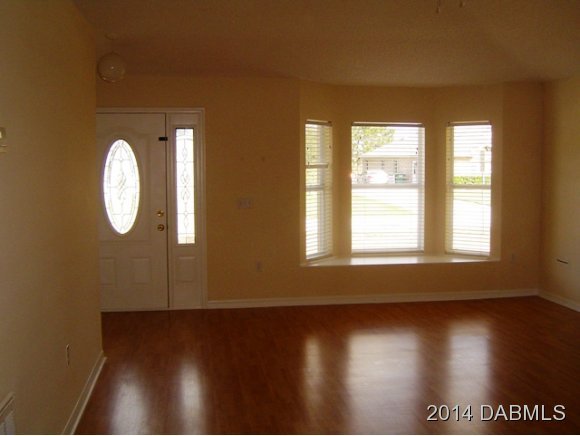 1710 Concert Road Deltona, FL 32738 - Photo 8 of 20 an empty room with wooden floor and windows
