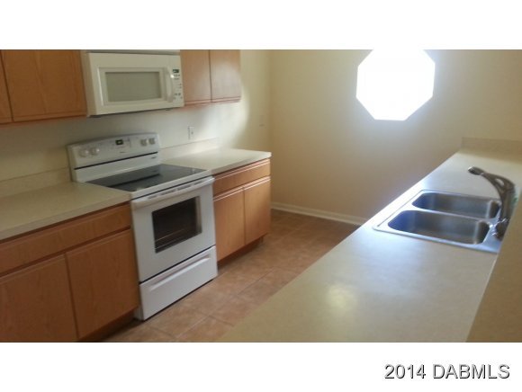 1710 Concert Road Deltona, FL 32738 - Photo 10 of 20 a kitchen with a stove and a microwave