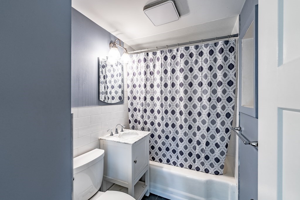 22 Ridge Road South Hadley, MA 01075 - Photo 16 of 36 a bathroom with a sink a toilet and shower curtain