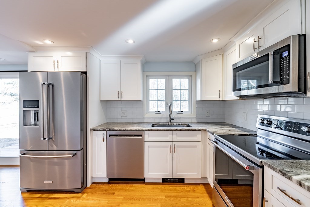 22 Ridge Road South Hadley, MA 01075 - Photo 4 of 36 a kitchen with stainless steel appliances granite countertop a stove a refrigerator and a microwave