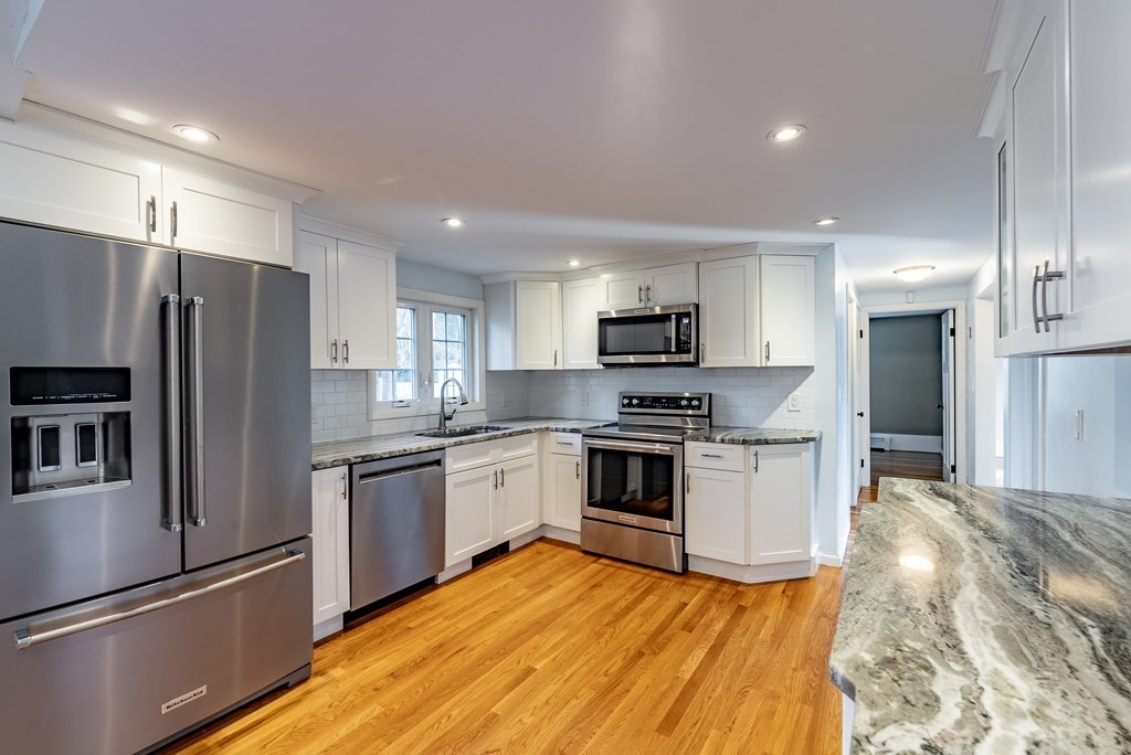 22 Ridge Road South Hadley, MA 01075 - Photo 7 of 36 a kitchen with granite countertop a refrigerator and a stove top oven