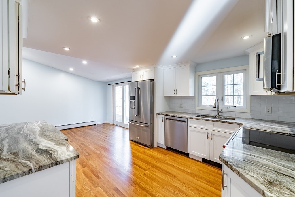 22 Ridge Road South Hadley, MA 01075 - Photo 8 of 36 a large kitchen with granite countertop a stove and a sink