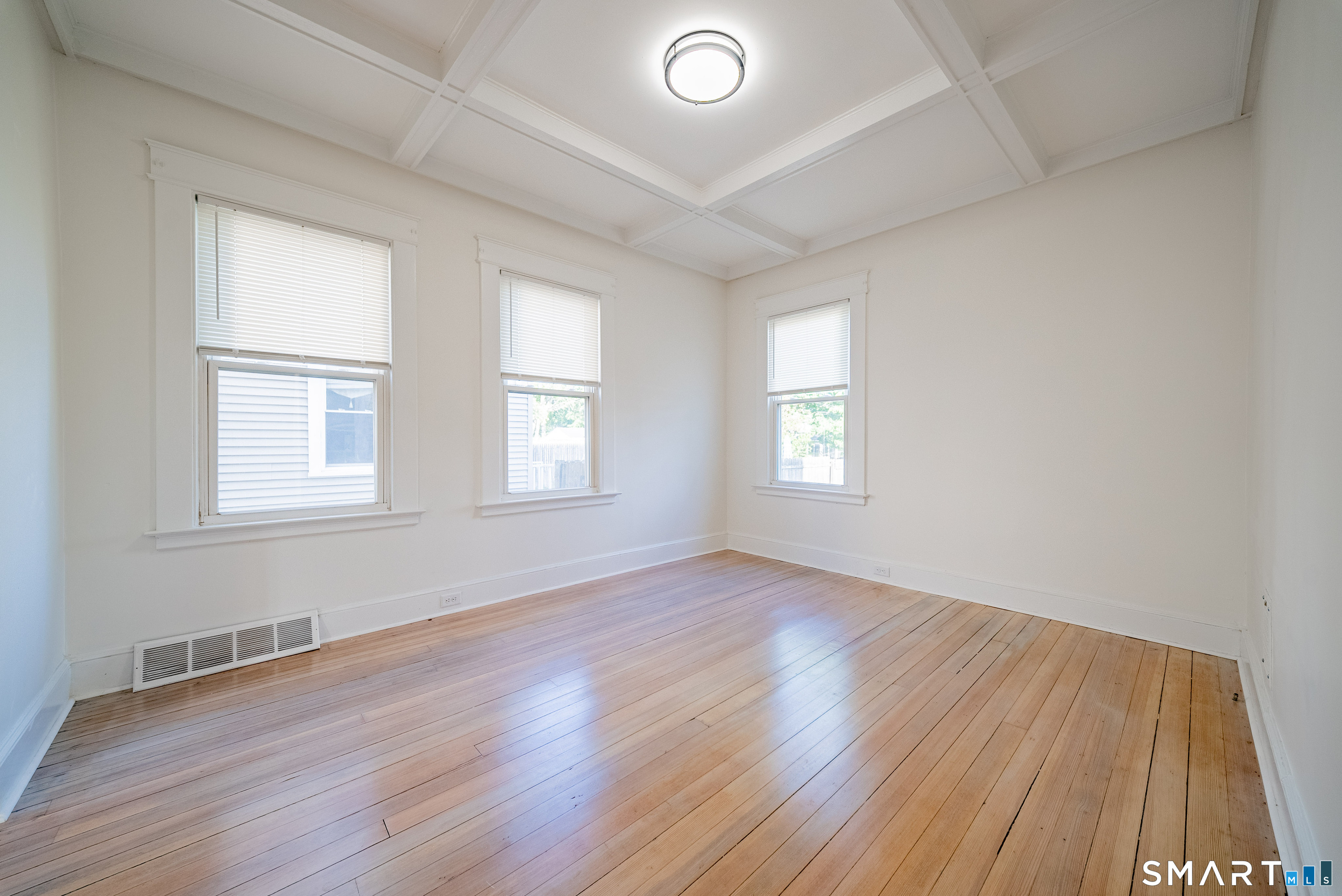 50 Jones Street West Haven, CT 06516 - Photo 8 of 21 an empty room with wooden floor and windows