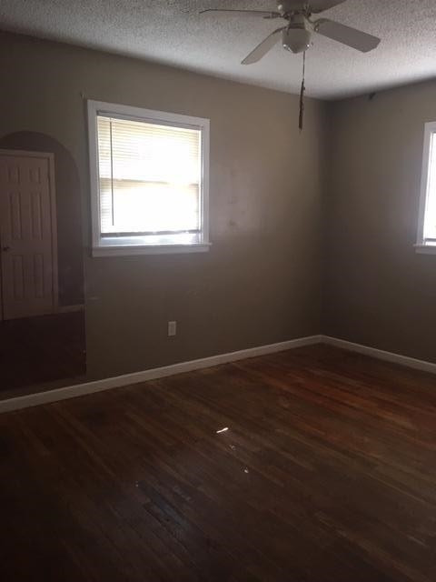 523 55th Street Lubbock, TX 79404 - Photo 7 of 9 a view of an empty room with wooden floor and a window