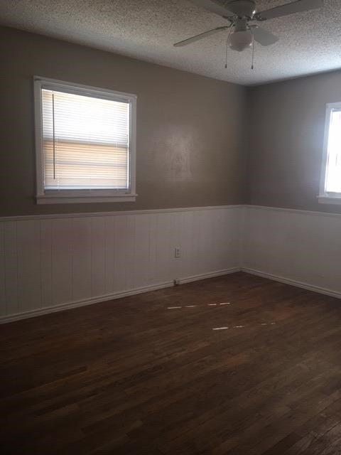 523 55th Street Lubbock, TX 79404 - Photo 8 of 9 an empty room with wooden floor and windows
