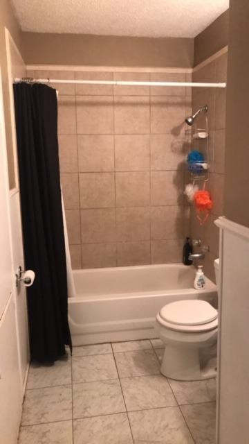 523 55th Street Lubbock, TX 79404 - Photo 9 of 9 a bathroom with a toilet a sink and bathtub
