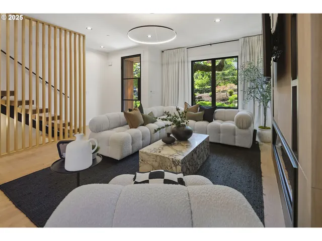 a living room with furniture kitchen view and a large window