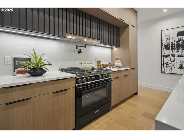 a kitchen with stainless steel appliances kitchen island granite countertop a sink and cabinets