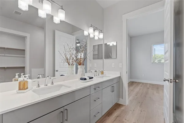 a bathroom with a sink double vanity and a mirror