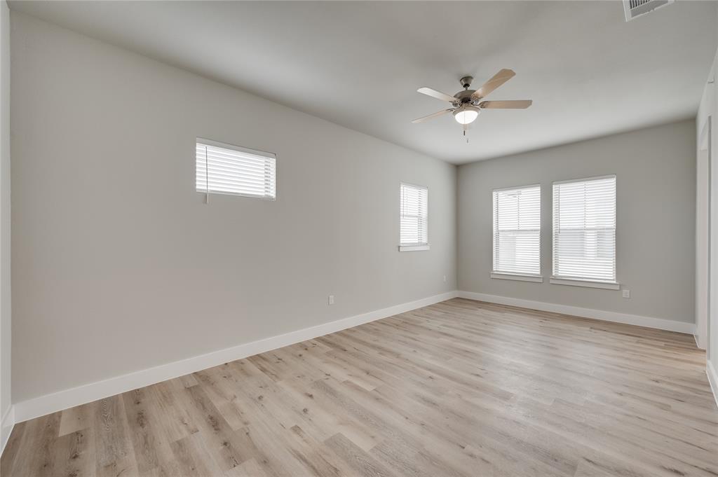 579 Lloyd's Road, Unit 820B Little Elm, TX 75068 - Photo 22 of 37 an empty room with wooden floor fan and windows