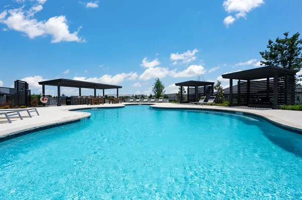 a view of a swimming pool with an outdoor seating